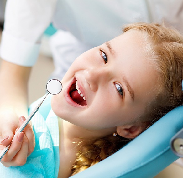 Little girl laughing during dental checkup