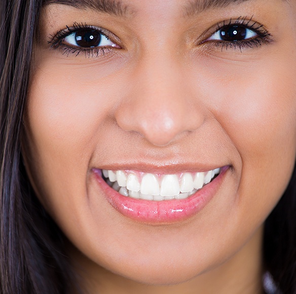 Woman with properly aligned smile after Invisalign treatment