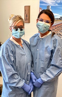 Two dental team members in protective equipment