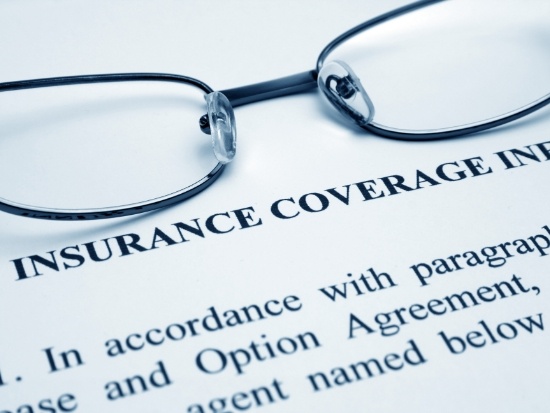 Glasses on top of a dental insurance coverage form