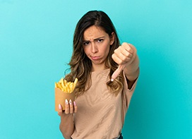 Young woman thumbs downing fries