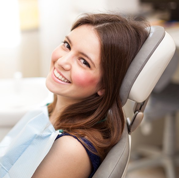Relaxed woman in dental chair for preventive dentistry