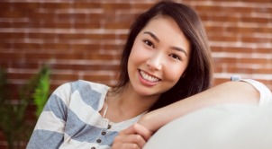 Young woman with straight smile after Invisalign orthodontic treatment
