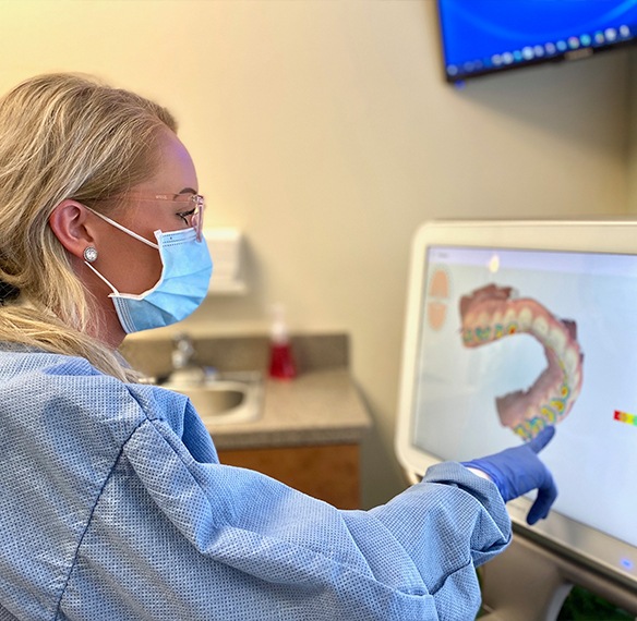 Dental team member looking at iTero digital impression system