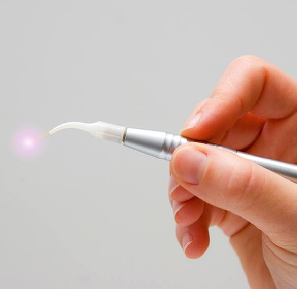 Hand holding soft tissue dental laser