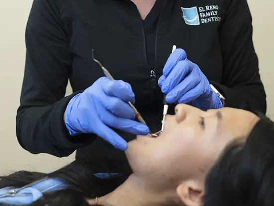 Female dental patient receiving restorative dentistry in El Reno