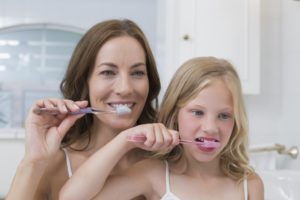 mother and child brushing together