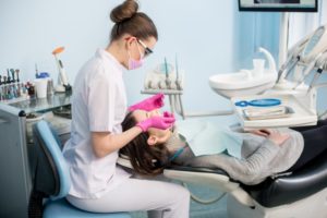 dental hygienist performing a cleaning 