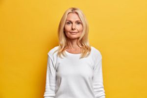 middle-aged woman against yellow background 