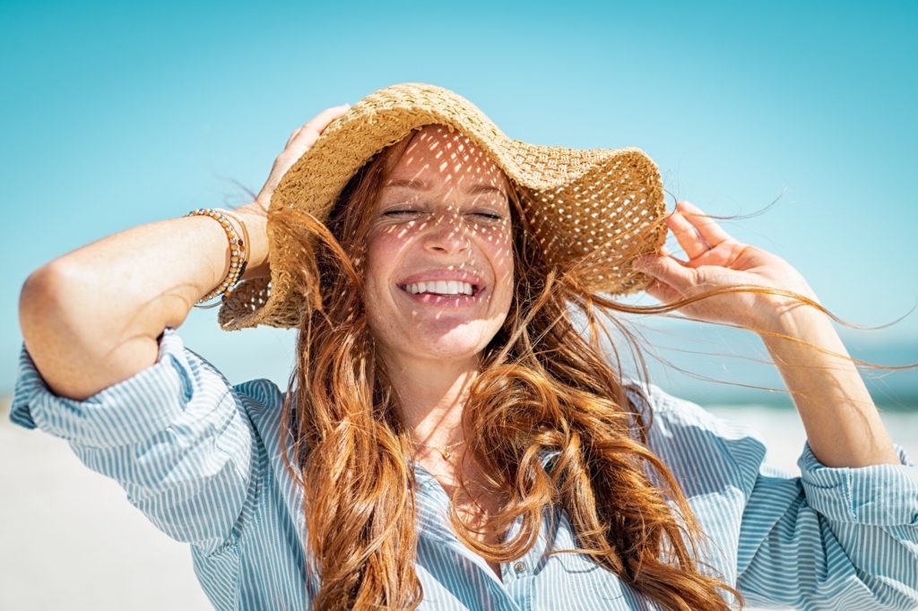 Woman with beautiful smile enjoying time in the sun