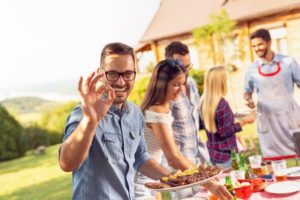 man smiling at a BBQ 