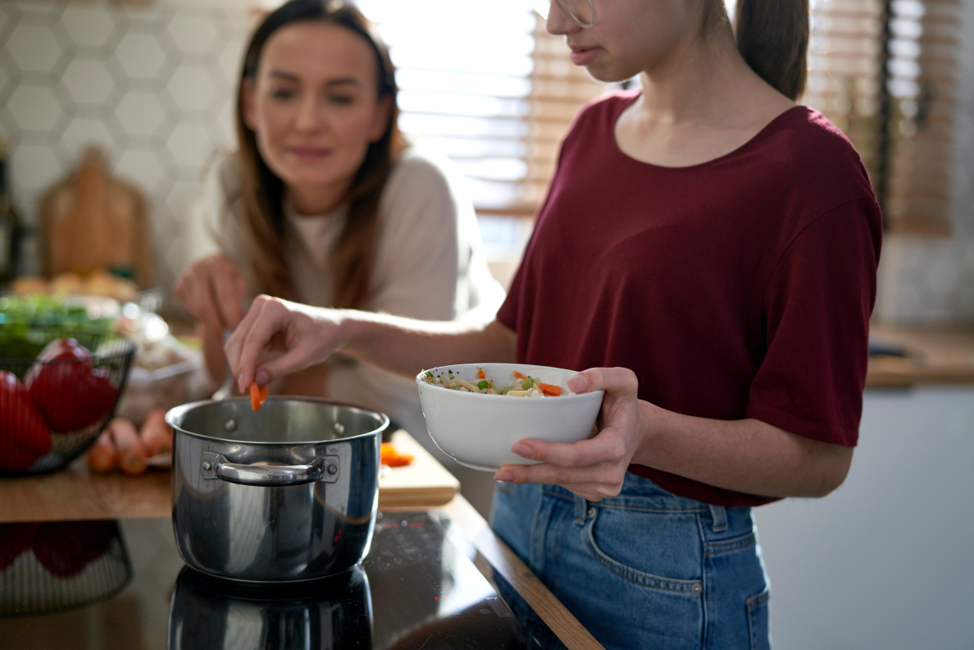woman preparing soup